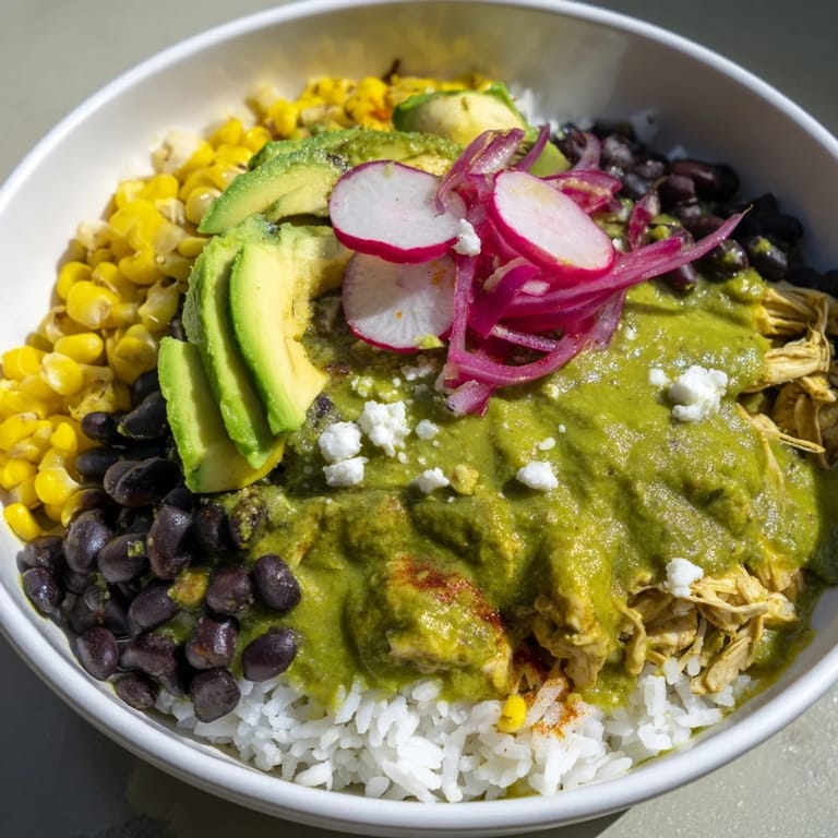 This Green Enchiladas Rice Bowl features fluffy rice, black beans, and fresh toppings, ready to enjoy.