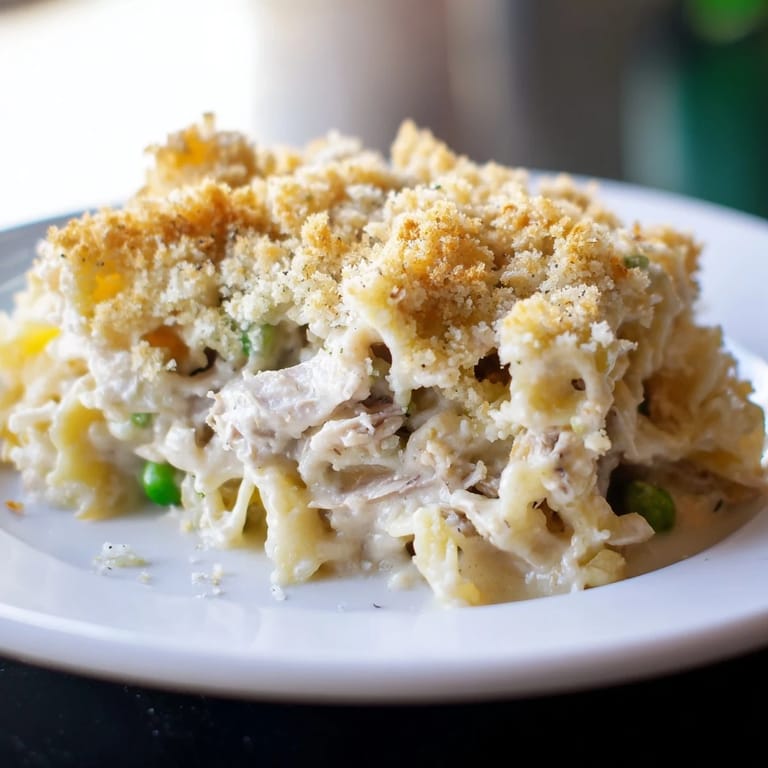 A warm, inviting shot of creamy tuna noodle casserole with cheesy topping made from crackers.
