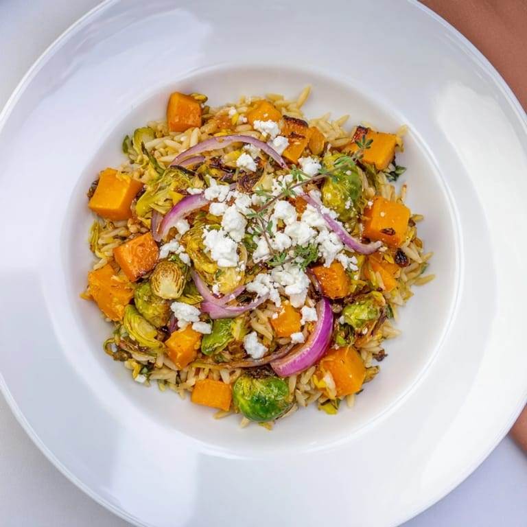 A colorful close-up of the Best Fall Harvest Orzo Salad, showcasing tender vegetables and maple balsamic dressing.