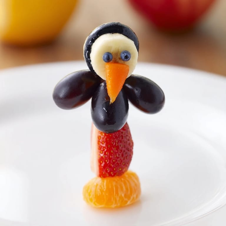 Freshly assembled Penguin Fruit Skewer Army: a vibrant and creative fruit snack idea for party treats.