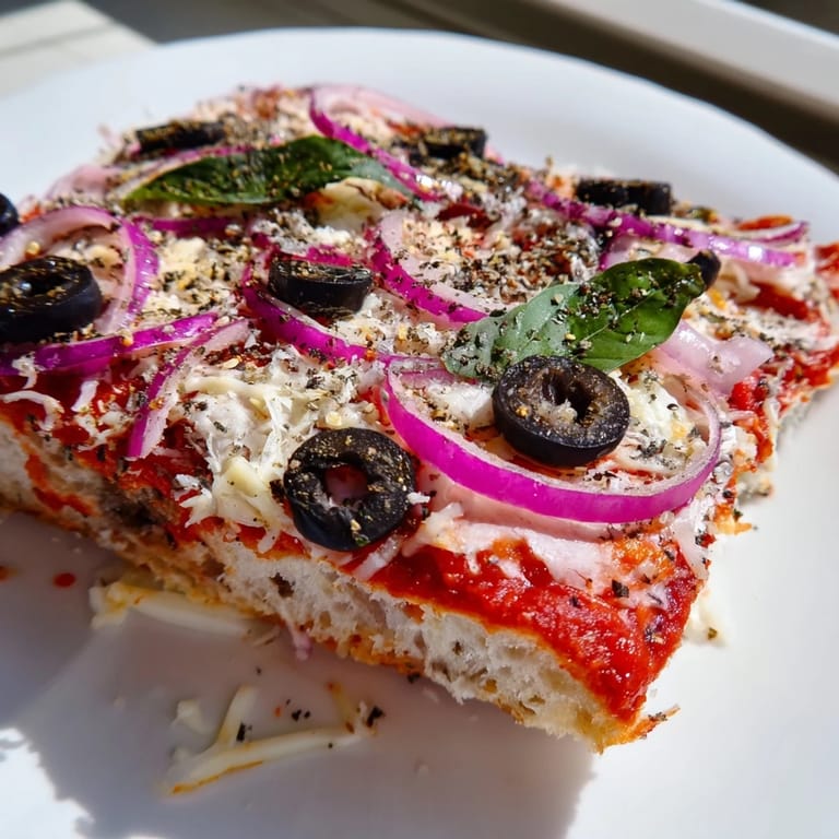 Close-up of baked Pizza Toast 2.0, showcasing gooey mozzarella cheese and crispy, browned edges.