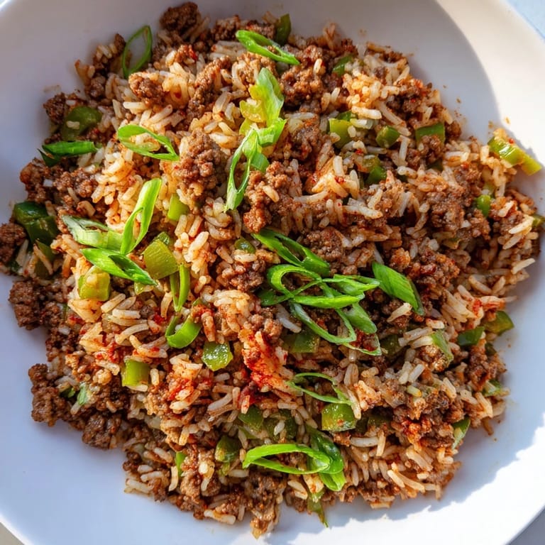 Golden, fluffy Cajun Dirty Rice, garnished with green onions, ready to eat and enjoy.