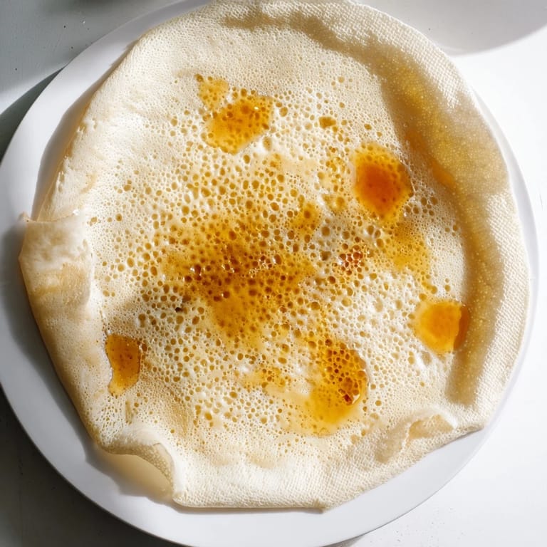 A stack of spongy Moroccan Baghrir: these North African pancakes, ideal for breakfast or dessert.