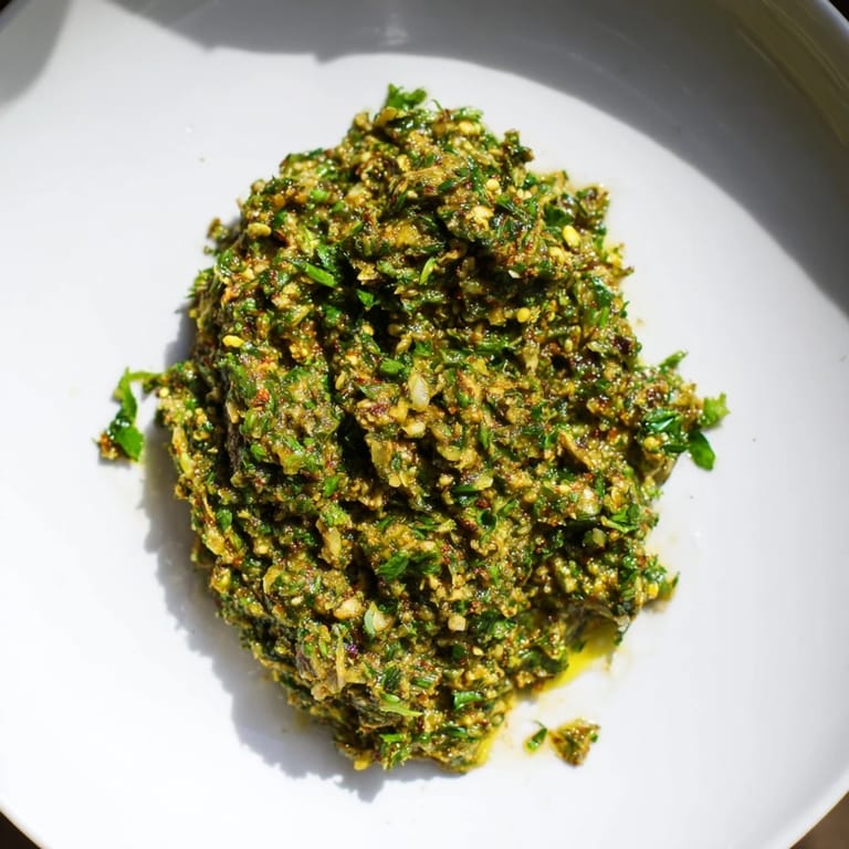 Aromatic, spicy Moroccan Chermoula Marinade ready to coat flaky fish fillets, perfect for grilling.