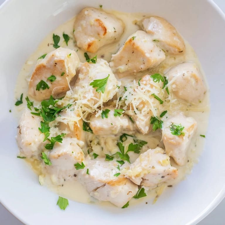 Savory Creamy Garlic Chicken Bites skillet dish featuring bite-sized chicken in a velvety sauce with melted Parmesan.