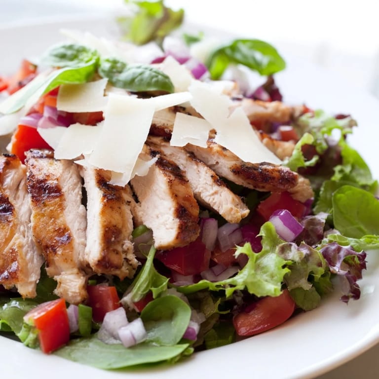 Savory Bruschetta Chicken Salad showcases juicy grilled chicken on mixed greens with a bright tomato-basil topping and Parmesan.