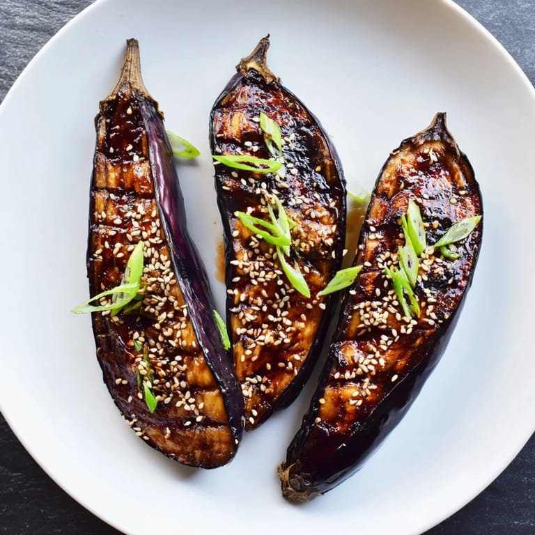 Silky miso glazed eggplant roasted tender, garnished with sesame seeds and scallions for dinner.