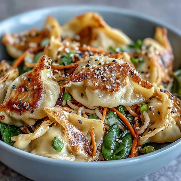 Serving suggestion for Potsticker Noodle Bowls topped with green onions and sesame seeds for a quick weeknight meal.