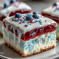 Patriotic Poke Cake: moist, colorful gelatin filling, creamy white chocolate.